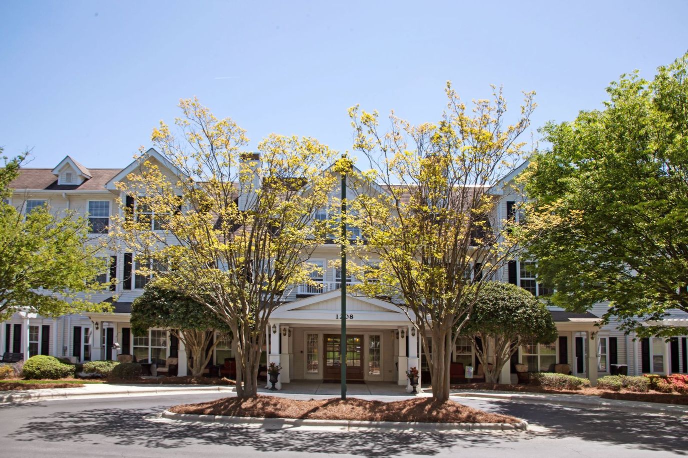 Exterior view of the facility with trees and landscaping