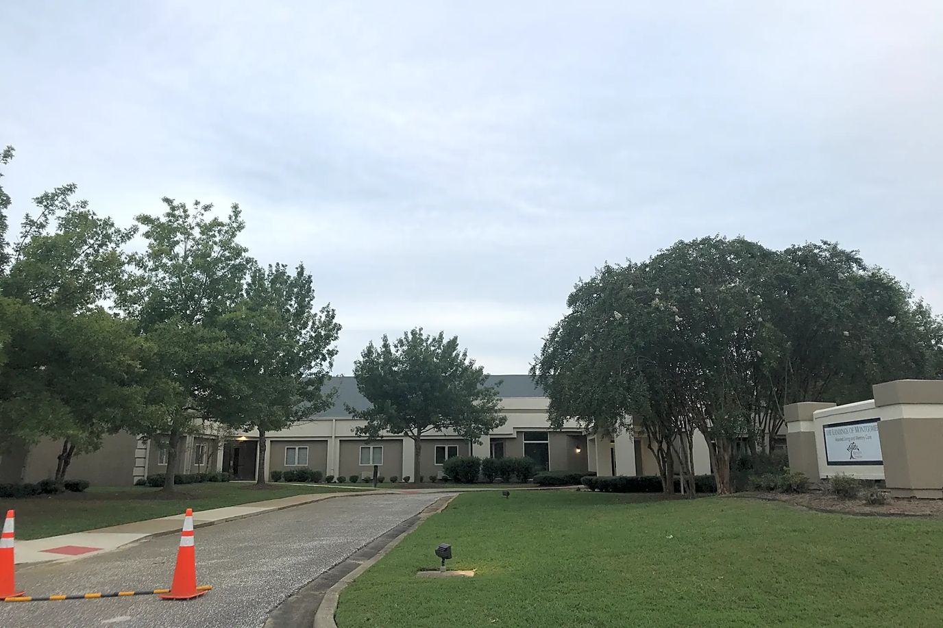 Exterior view of The Cedars facility with landscaping