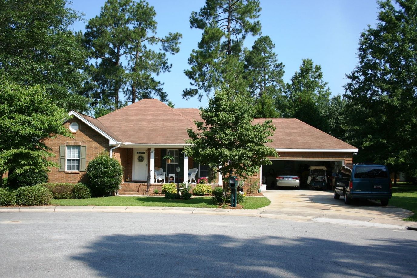 Exterior view of a senior living facility surrounded by trees