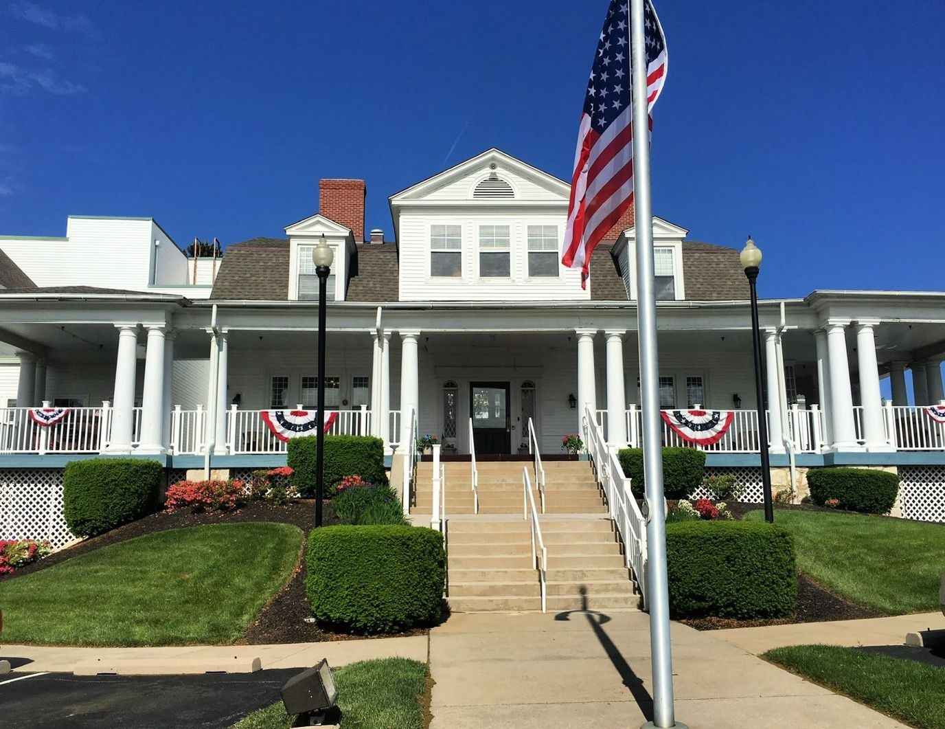 Exterior view of assisted living facility with American flag