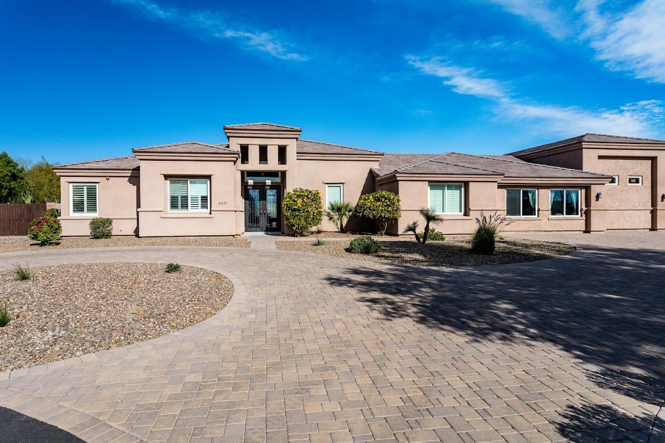 Exterior view of The Valencia Home with landscaped front