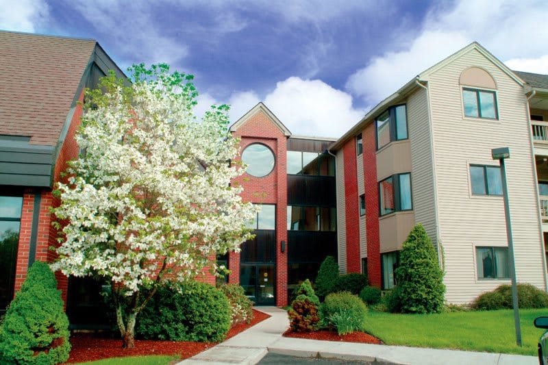 Exterior view of a senior living facility with landscaping