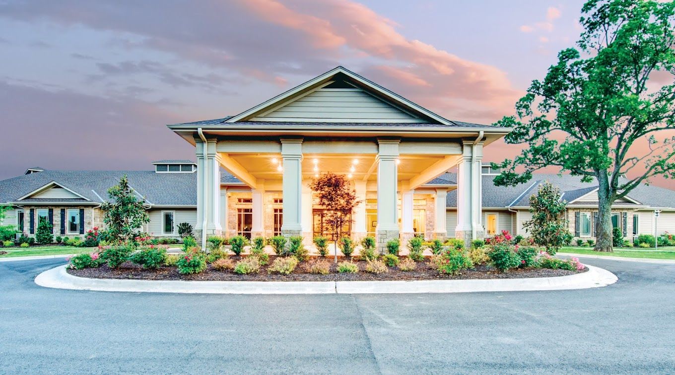 Building exterior of Village on the Park Rogers at sunset