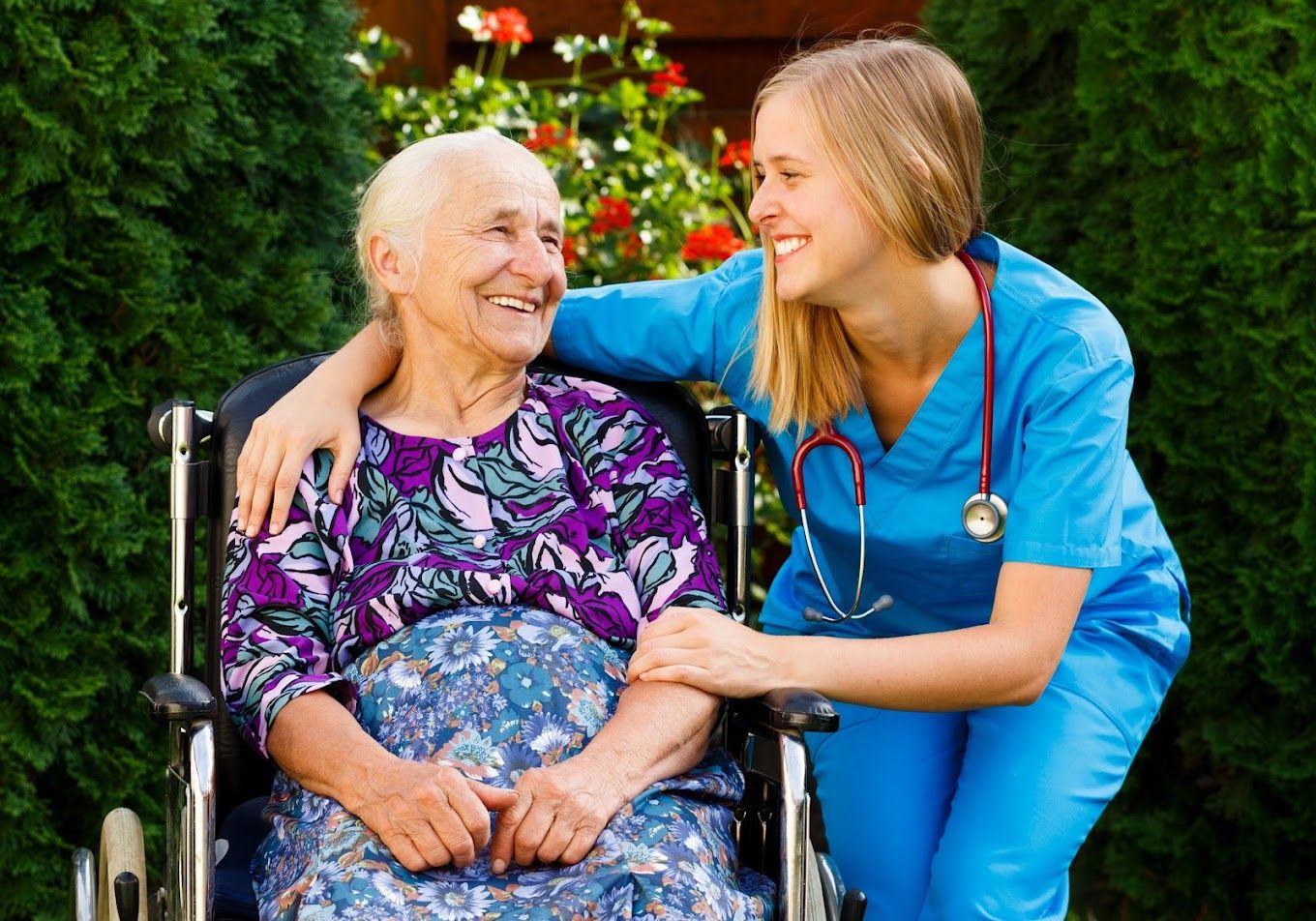 Caregiver and resident sharing a joyful moment outdoors