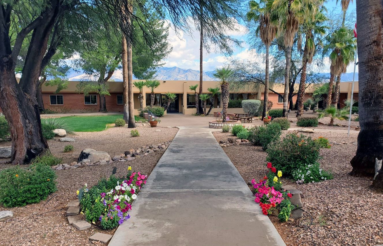 Pathway leading to a senior living facility surrounded by greenery