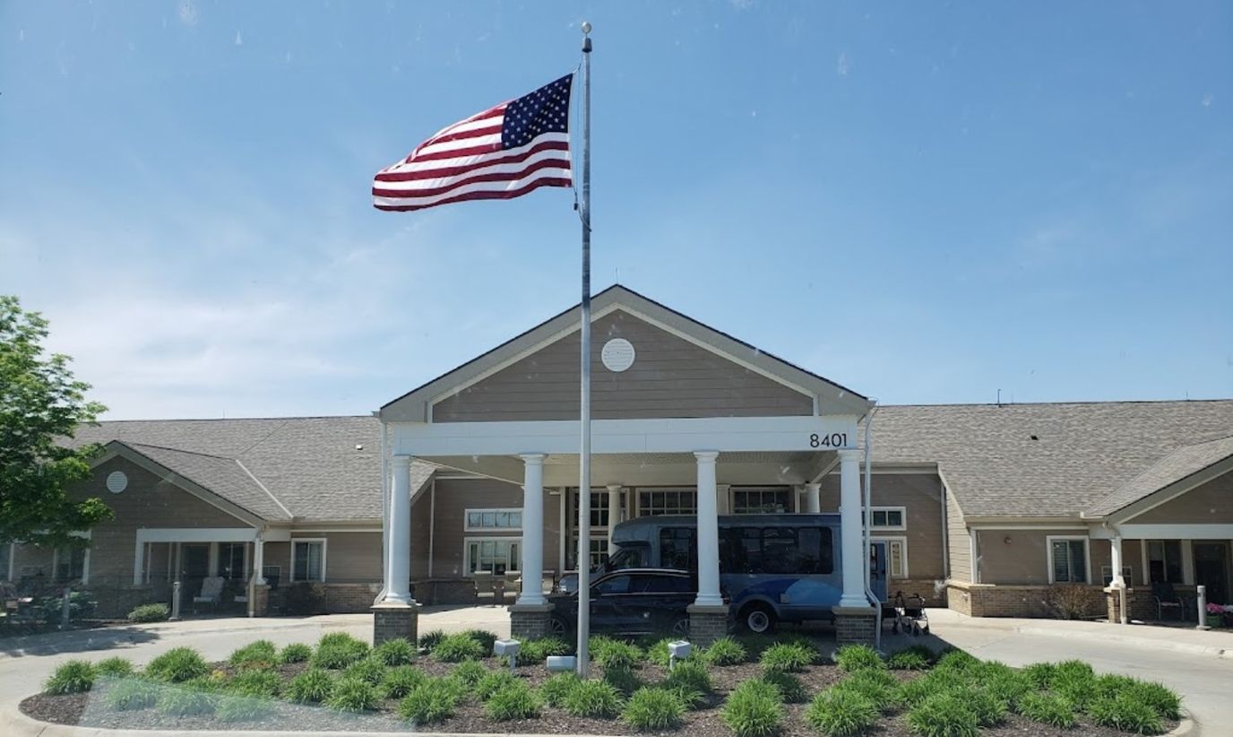 Front view of the facility with flag and transport vehicle