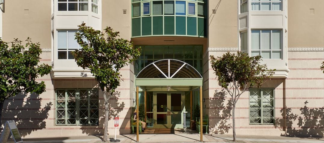 Entrance of Coventry Place facility with landscaped trees