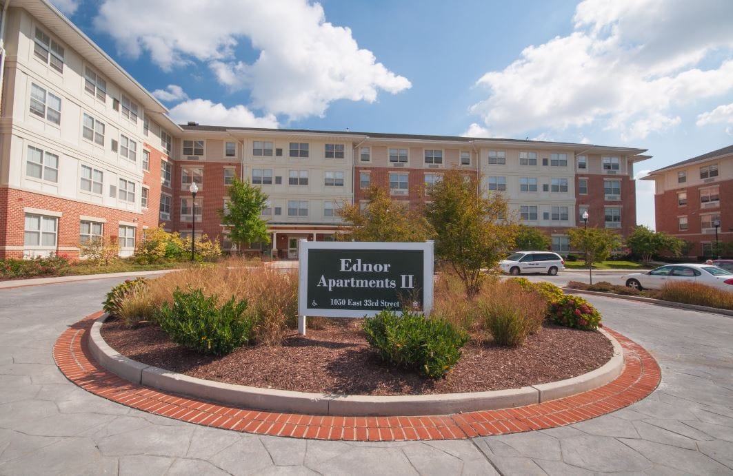 Exterior view of Ednor Apartments II with landscaped entrance