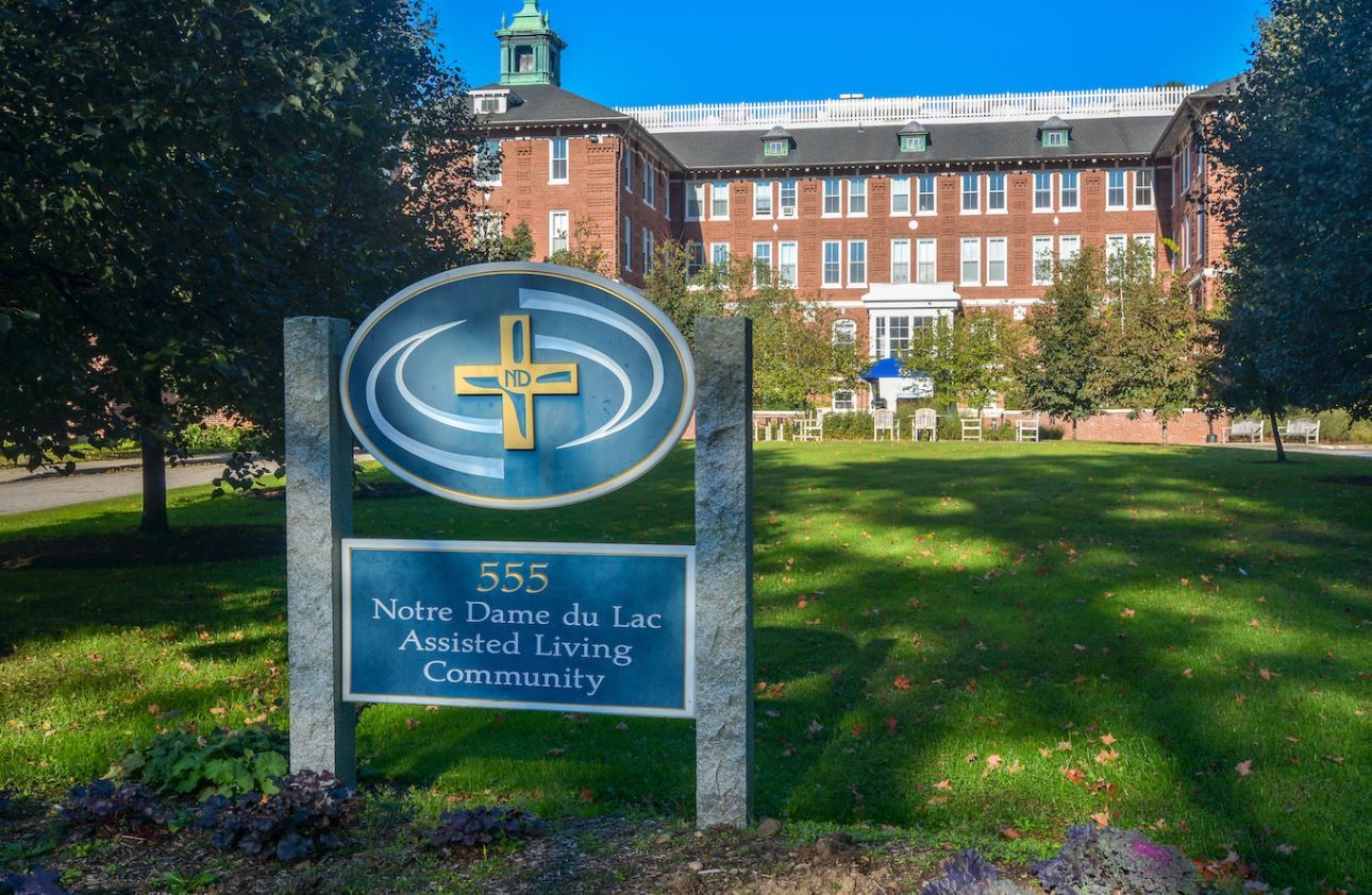 Facility logo in front of the assisted living building
