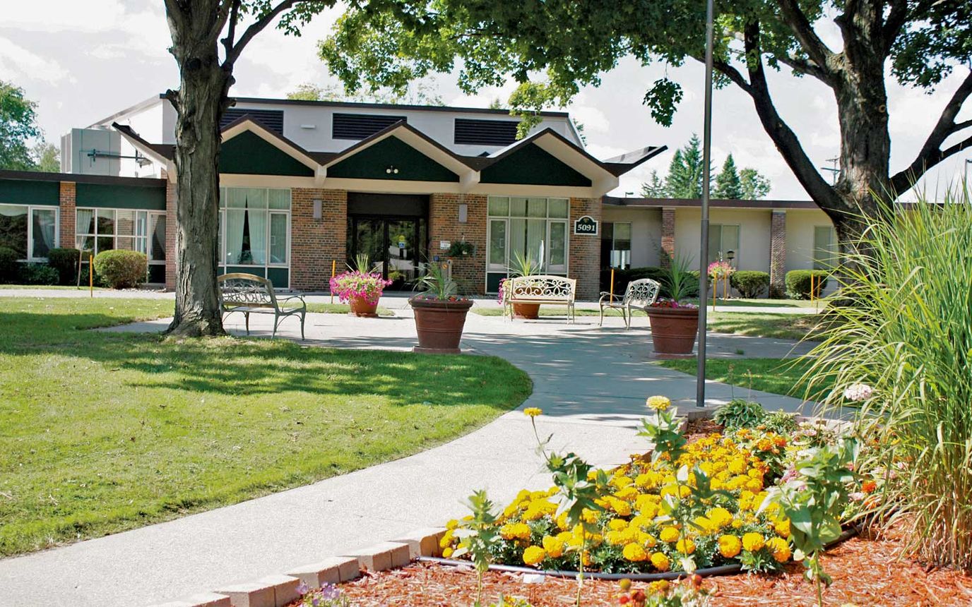 Exterior view of Holt Senior Care & Rehab Center with gardens