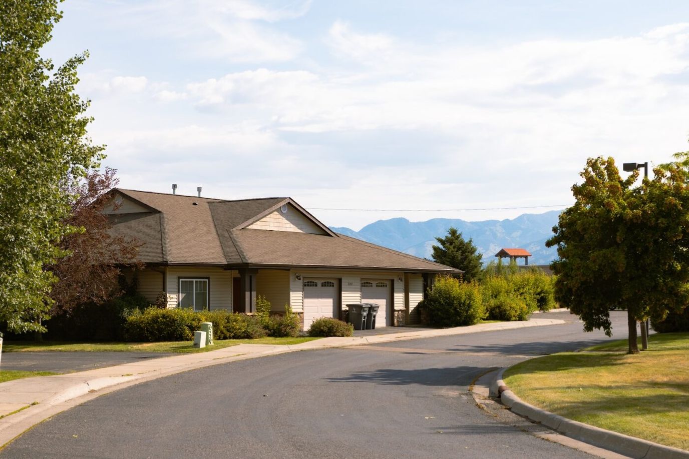 Exterior view of a senior living facility surrounded by greenery