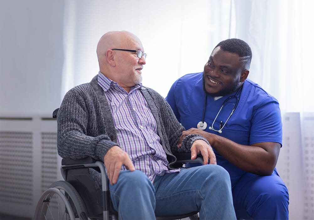 Caregiver assisting a resident in a bright room