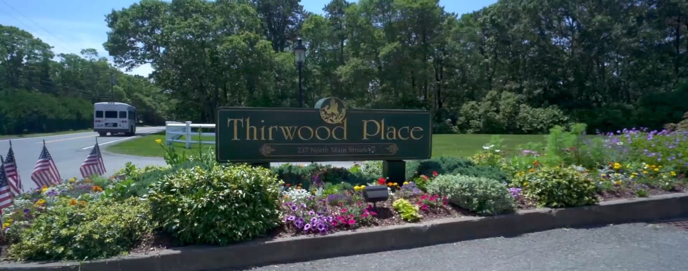 Signage with the name of Thirwood Place amidst flowers