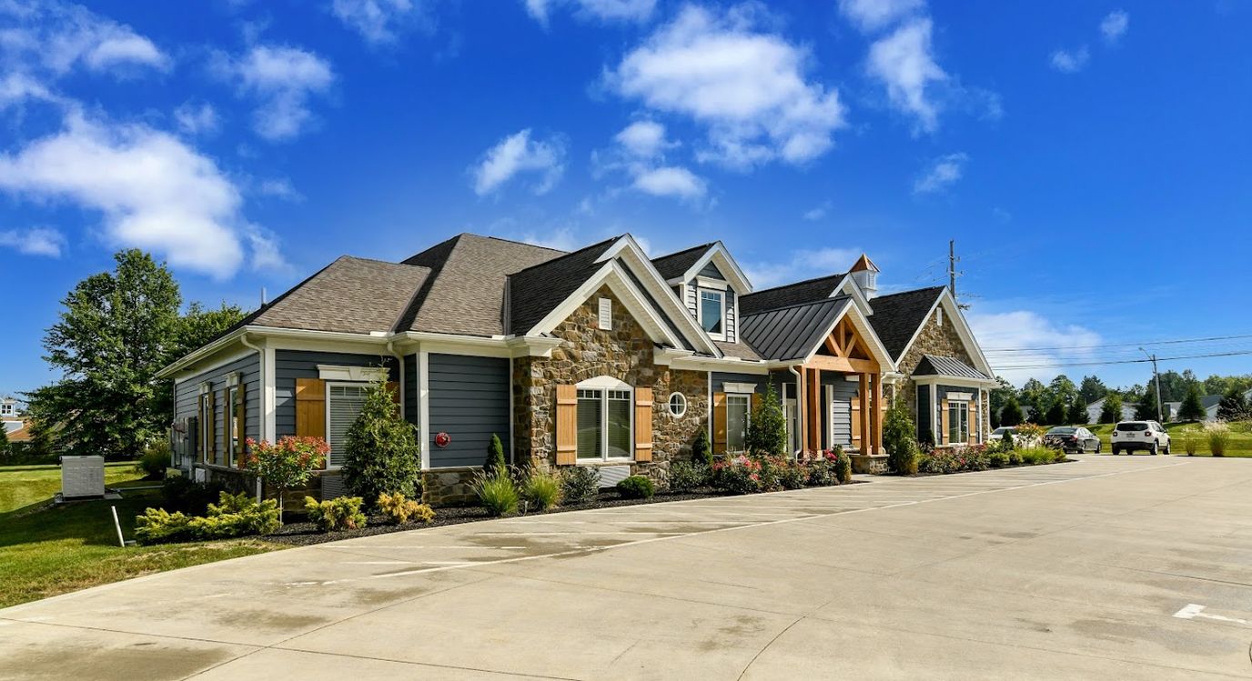 Exterior view of a senior living facility with gardens