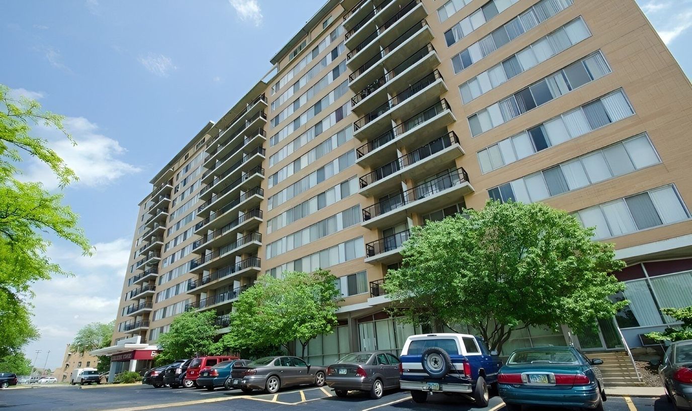 Exterior view of a senior living facility with parking