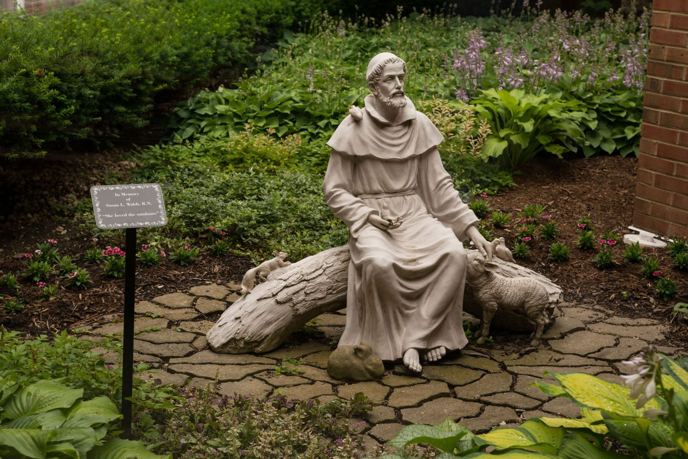 Statue of a saint in a garden area
