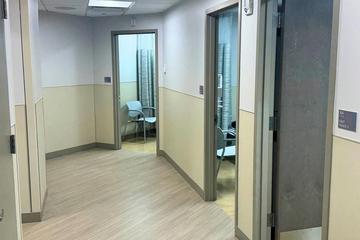 Interior hallway with light-colored walls and chairs