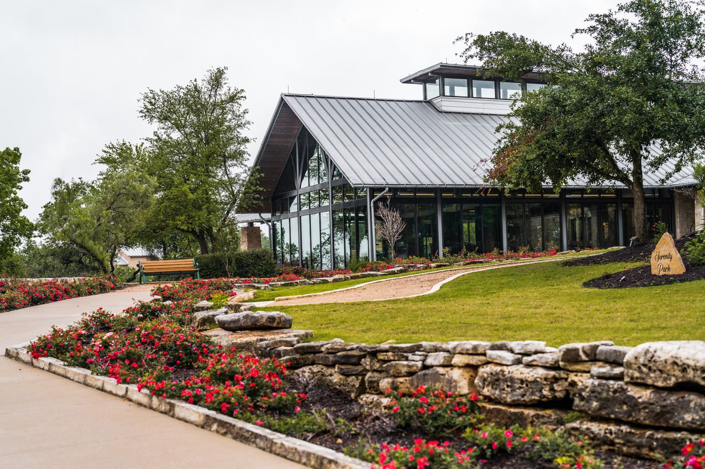 Exterior view of a senior living facility with gardens