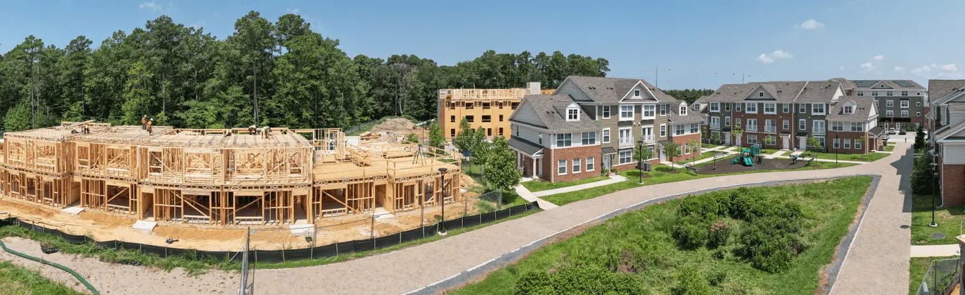 Construction site with partially completed building and landscaping.