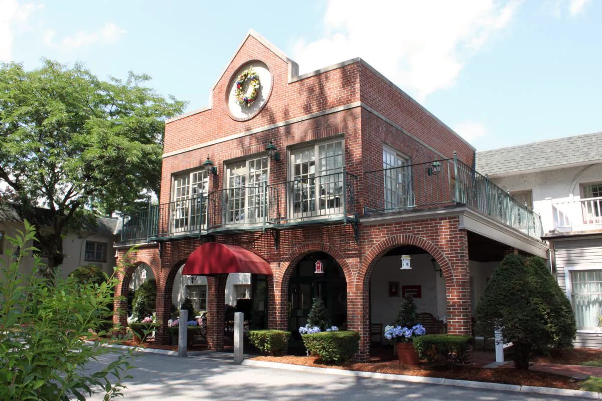 Exterior view of a nursing home facility with greenery