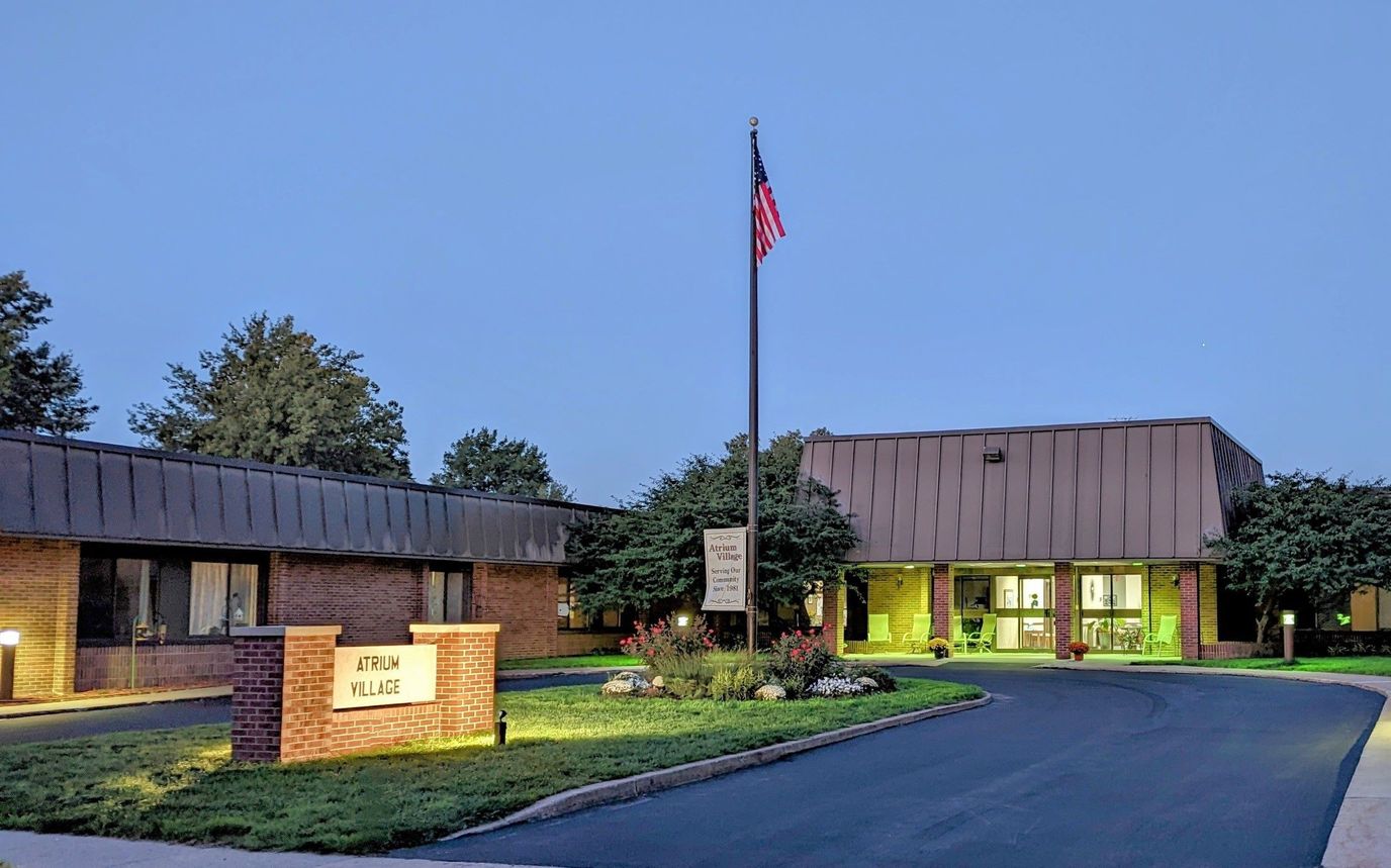 Front exterior of Atrium Village at dusk