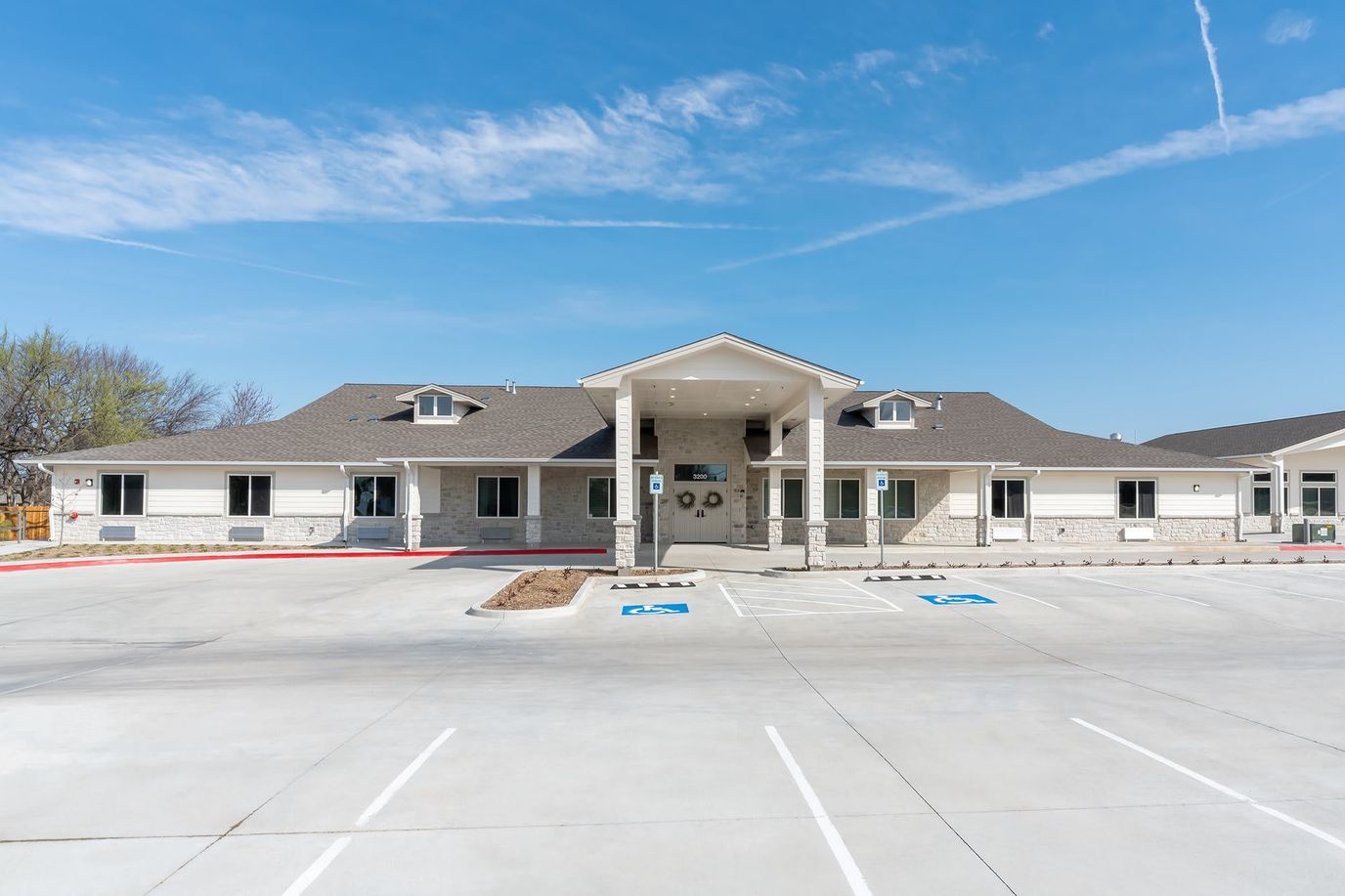Exterior view of BeeHive Homes facility with parking lot