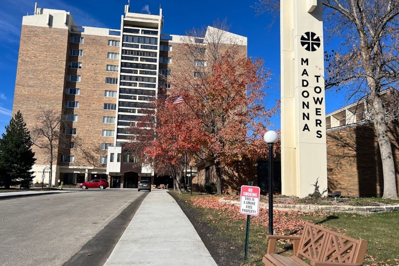 Exterior view of Madonna Towers building with autumn trees