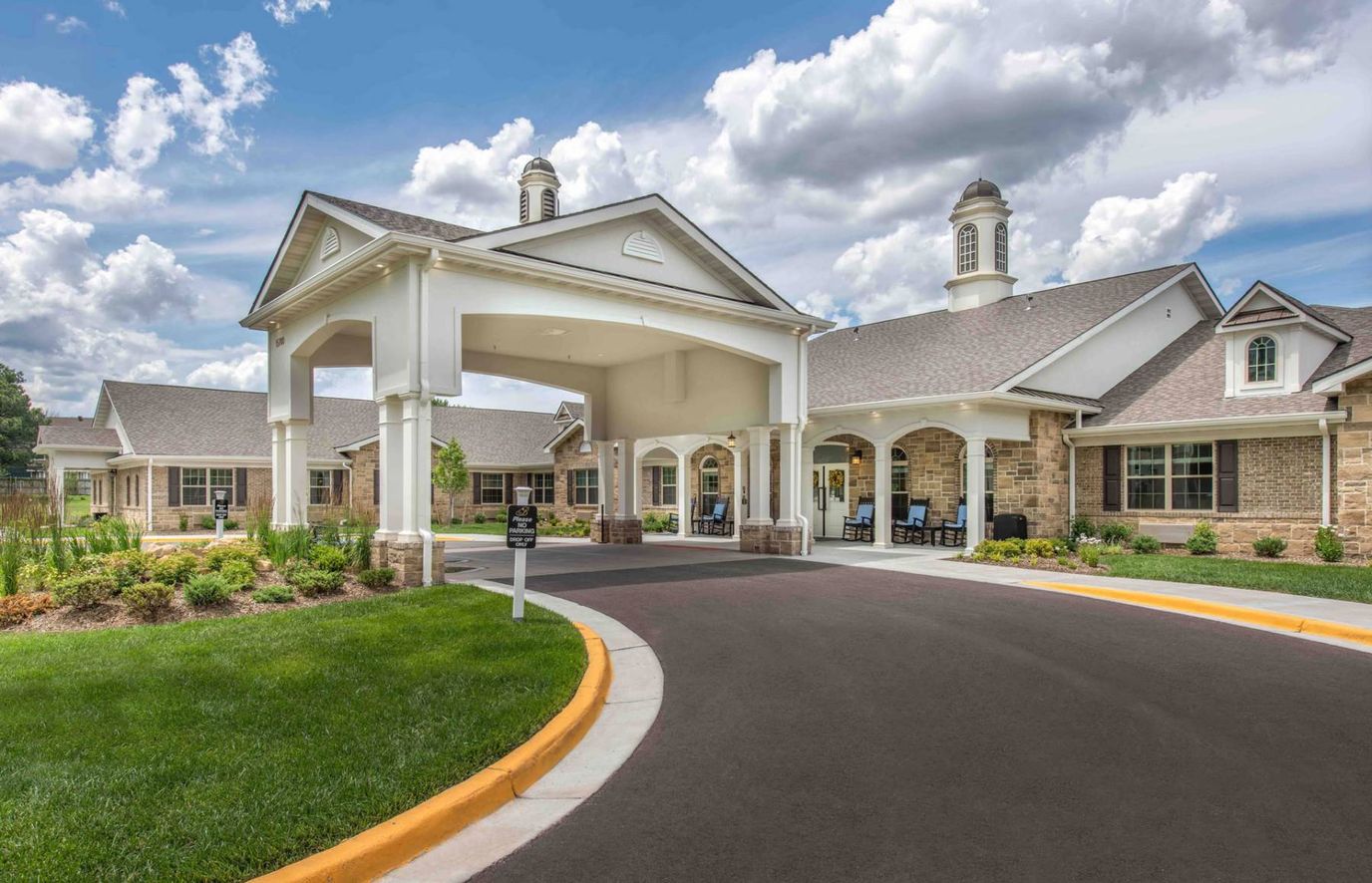 Exterior view of a senior living facility with gardens