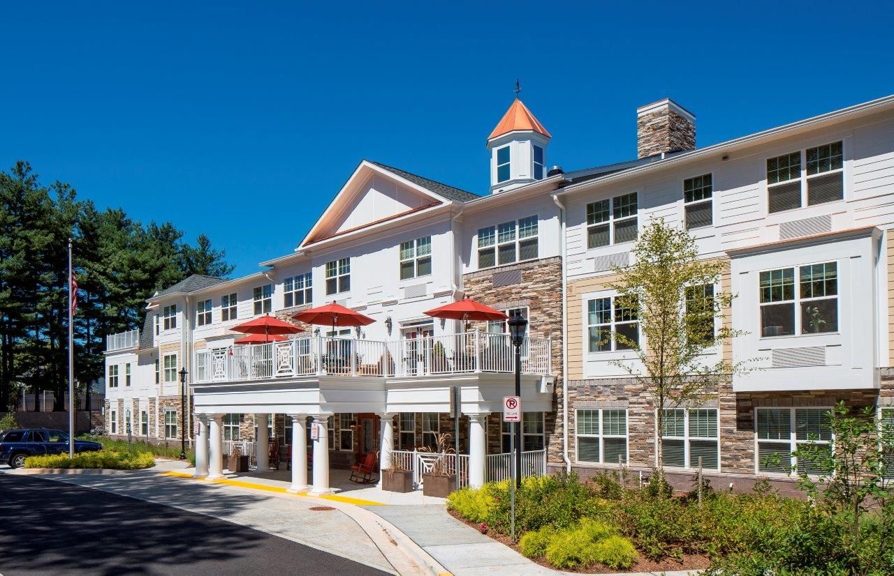 Exterior view of a senior living facility with garden areas