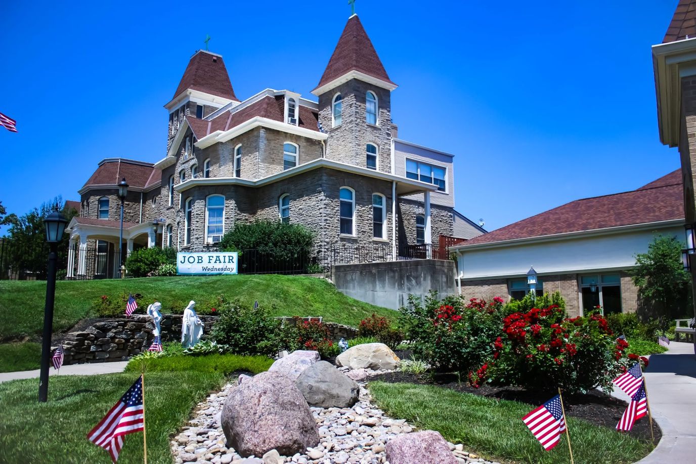Exterior view of assisted living facility with flower beds