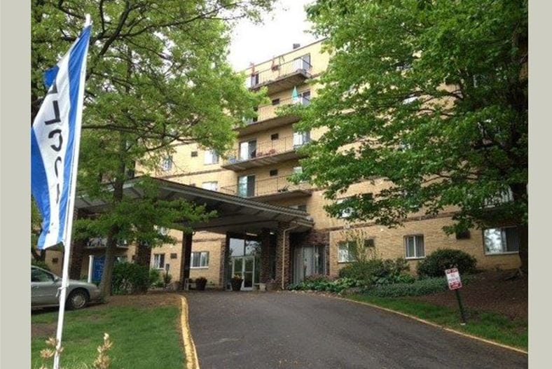 Chapel Hill Towers, independent living in Akron, OH — Entrance of a senior living facility surrounded by greenery