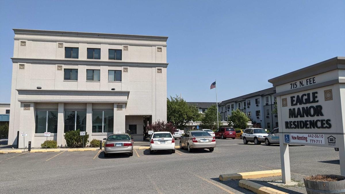 Exterior view of Eagle Manor Residences with parking area