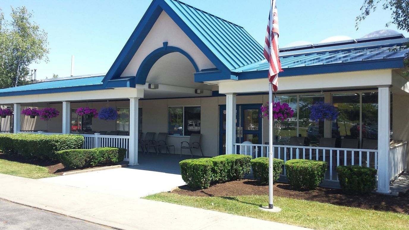 Exterior view of the assisted living facility with vibrant flowers