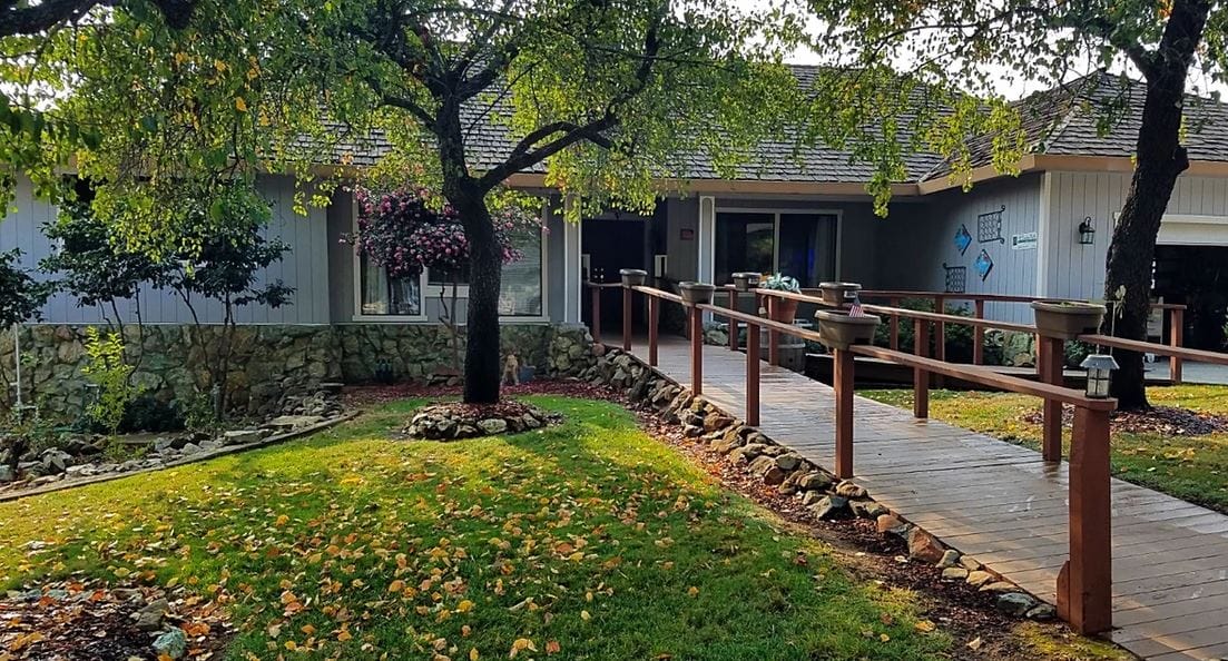 Exterior view of a senior care facility with landscaped garden