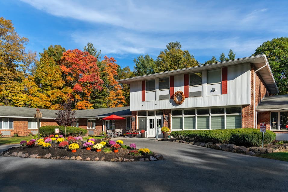 Exterior view of assisted living facility with colorful flowers