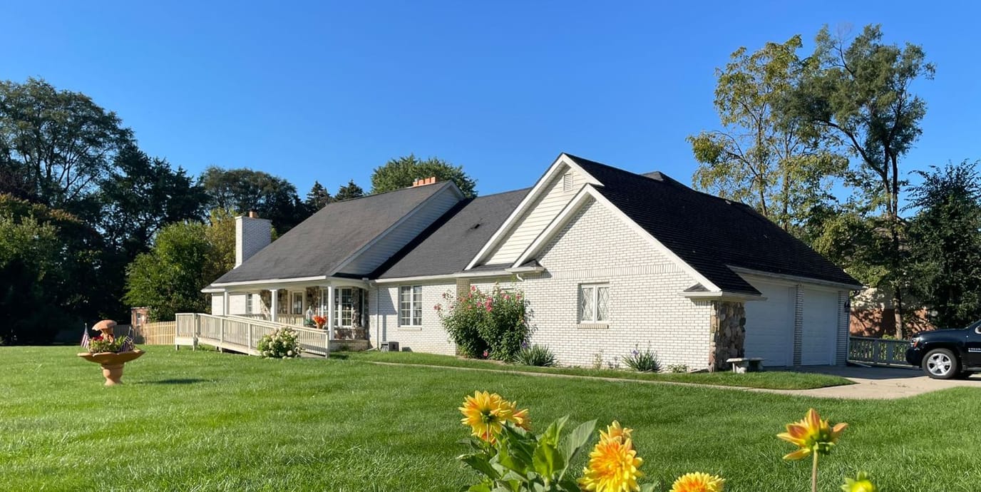 Exterior view of a senior living facility surrounded by greenery