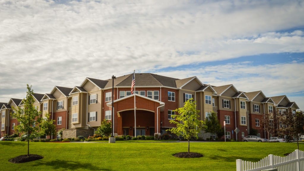 Exterior view of a senior living facility with landscaping