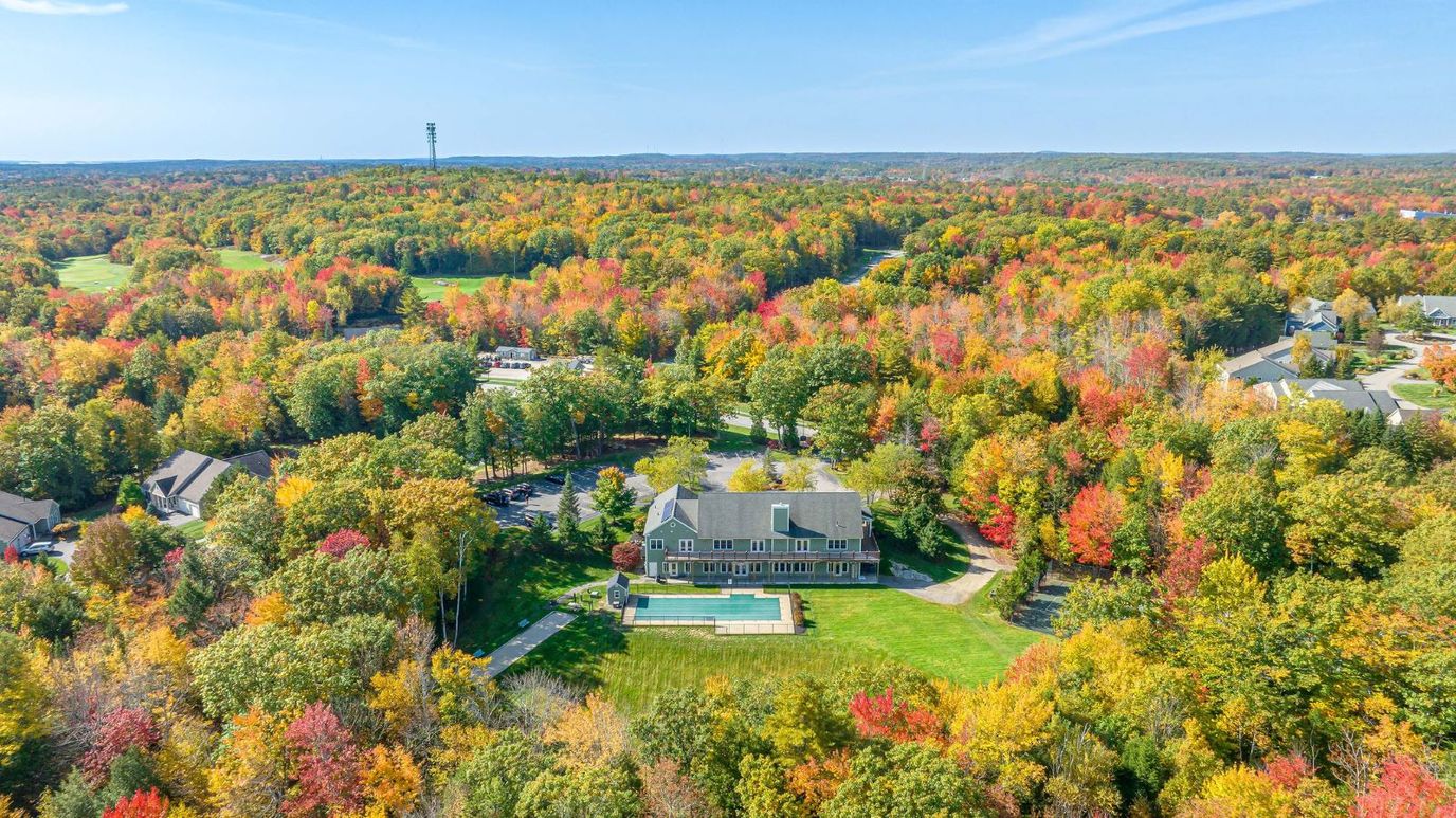 Aerial view of a senior living facility surrounded by fall foliage