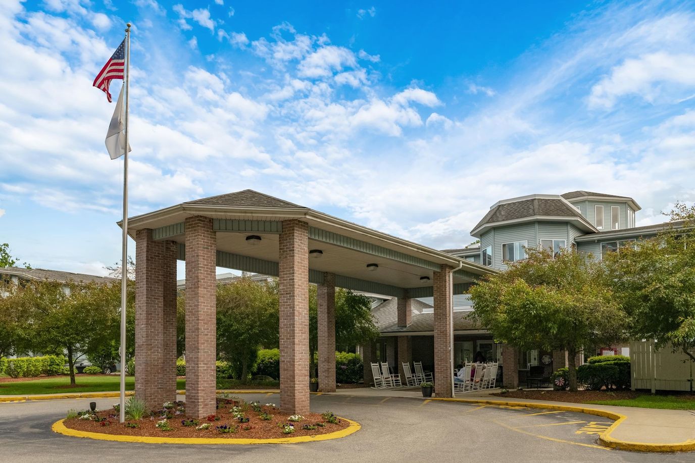 Entrance of a senior living community with a porch