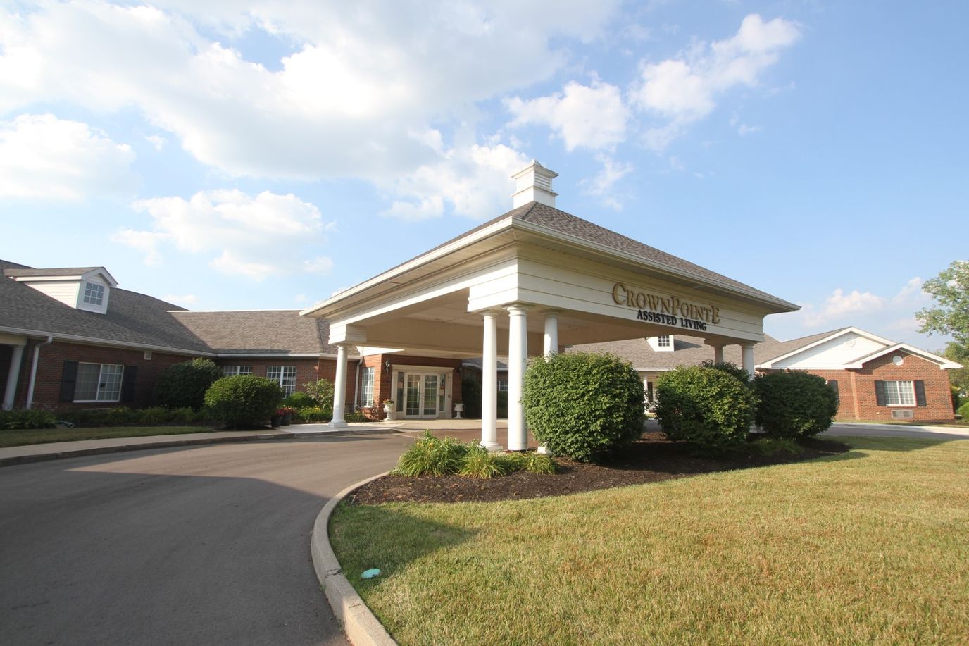 Entrance of CrownPointe of Carmel with landscaping and canopy