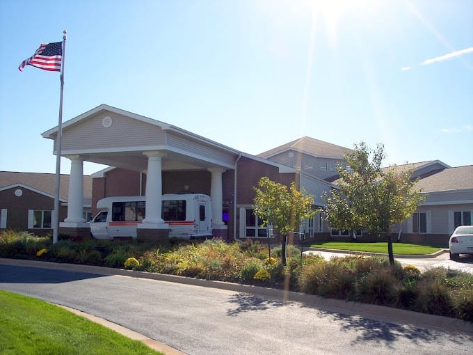 Exterior view of the facility with landscaping and transport van