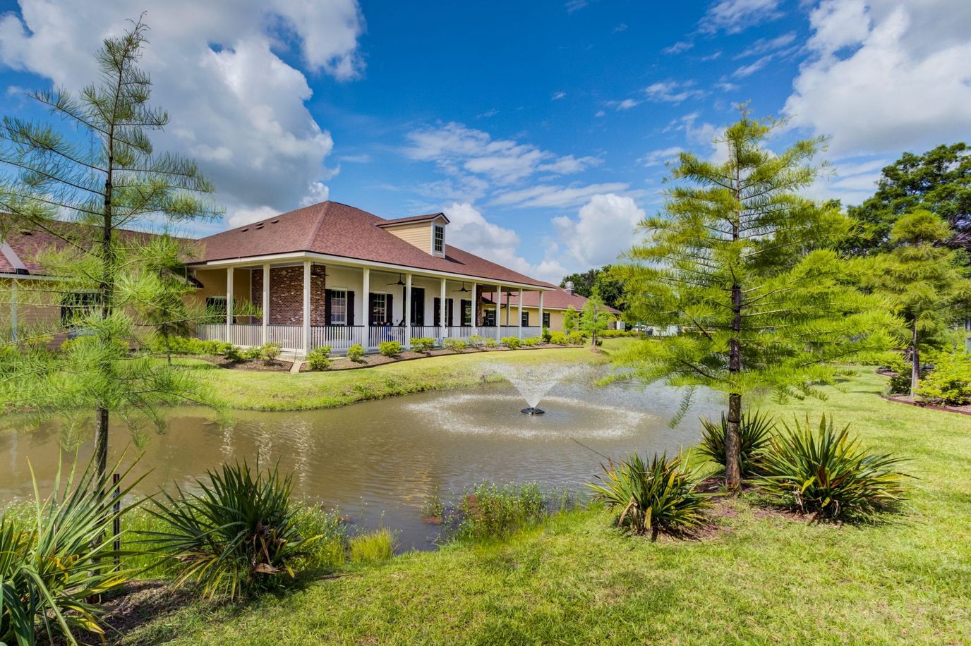 Exterior view of Camelot Rehabilitation with a pond