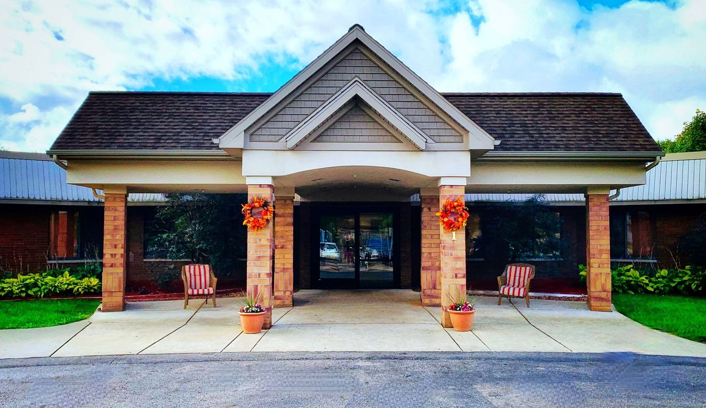 Front entrance of Medilodge of Capital Area with colorful flowers