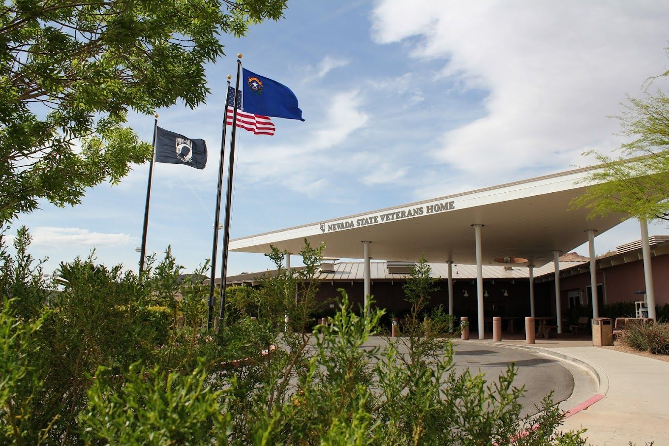 Exterior view of Nevada State Veterans Home with flags