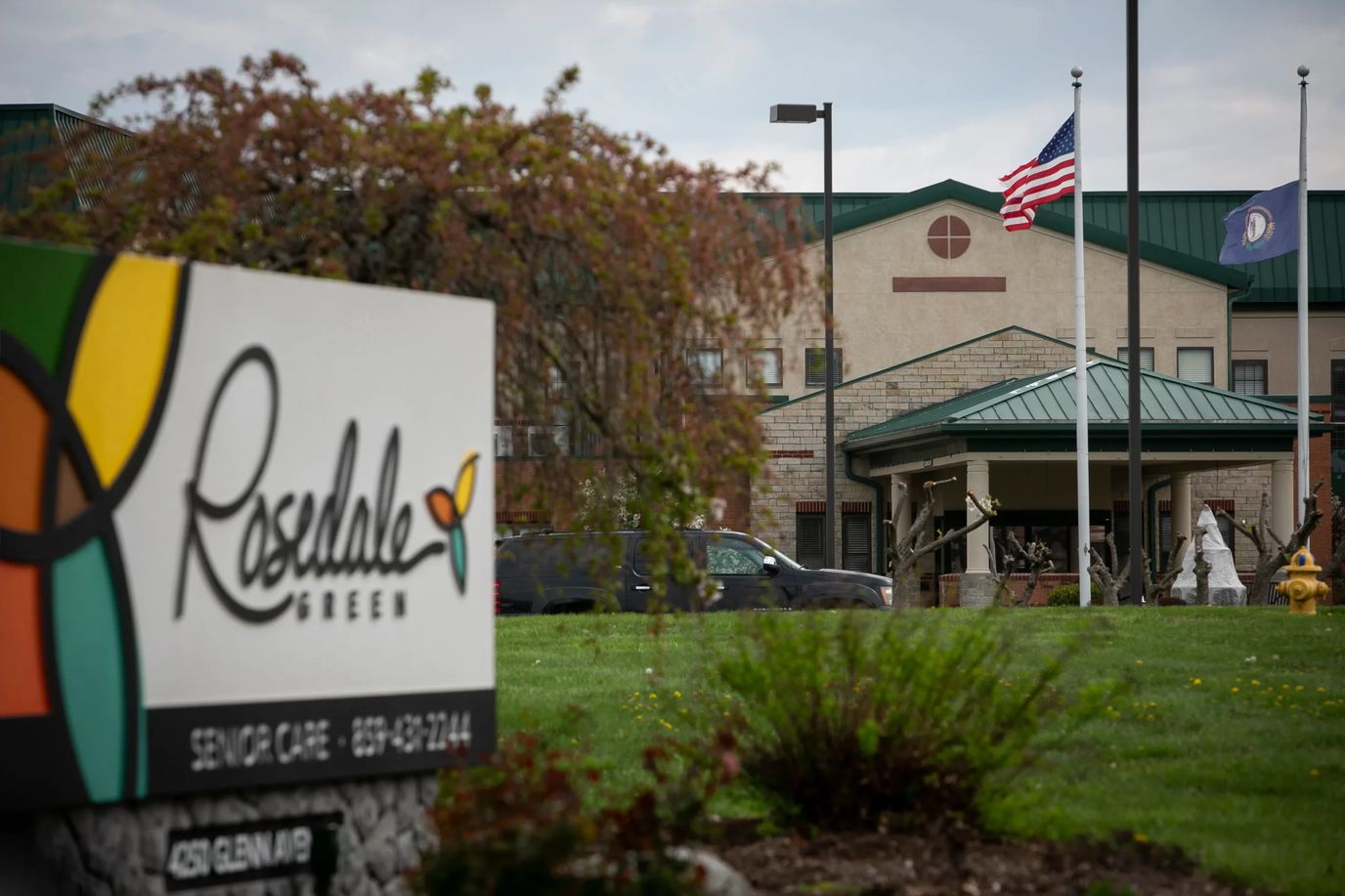 Sign for Rosedale Green facility with building in background