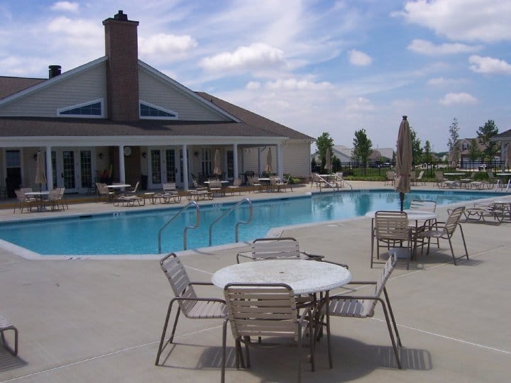 Swimming pool area with lounge chairs and tables