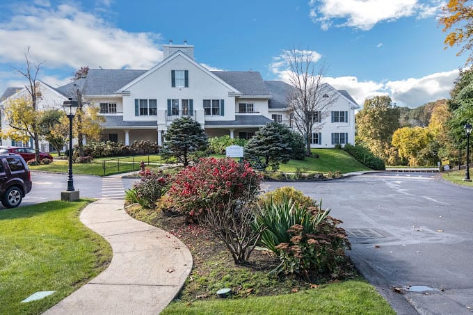 Exterior view of Springhouse Senior Living with landscaped entrance