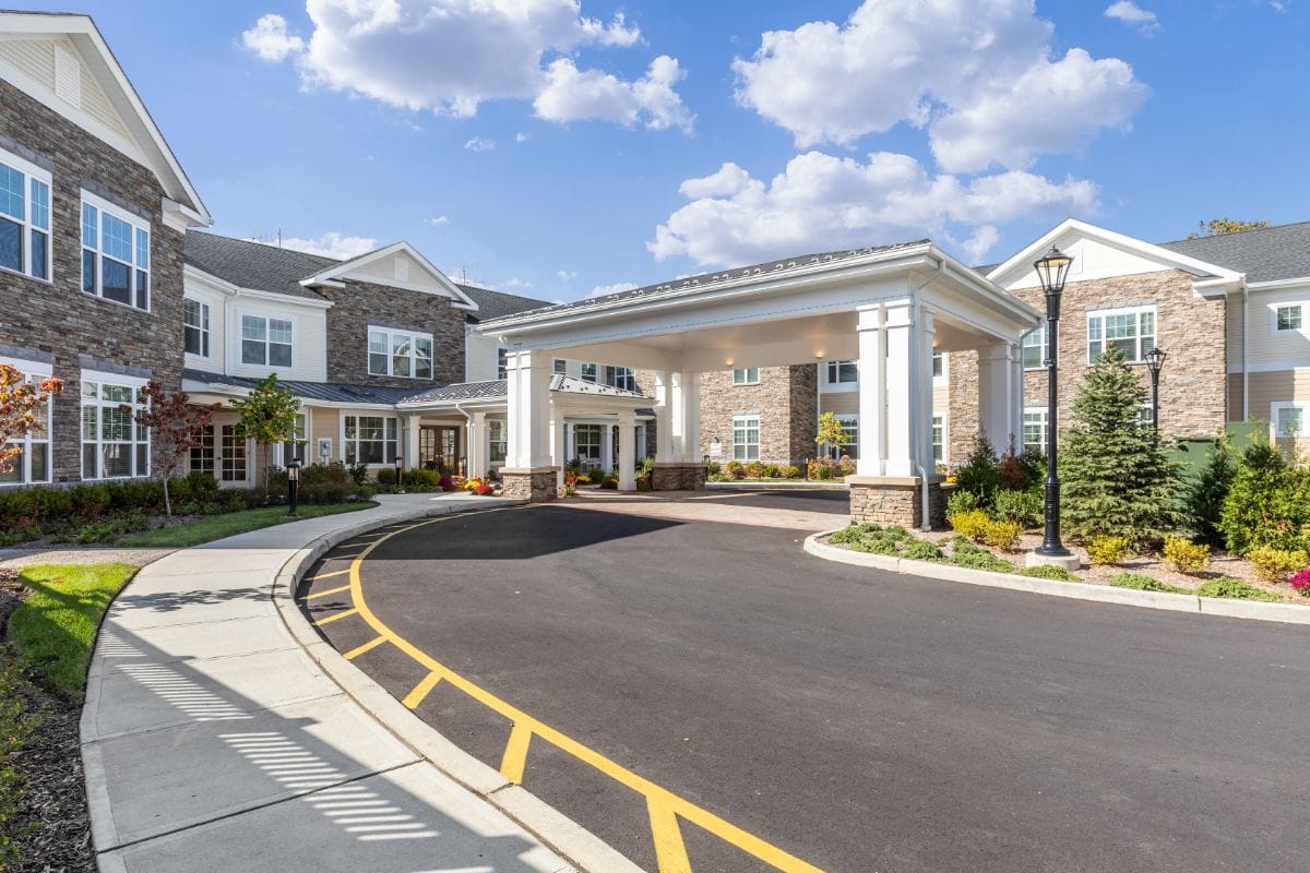 Front entrance of the assisted living facility with landscaped gardens