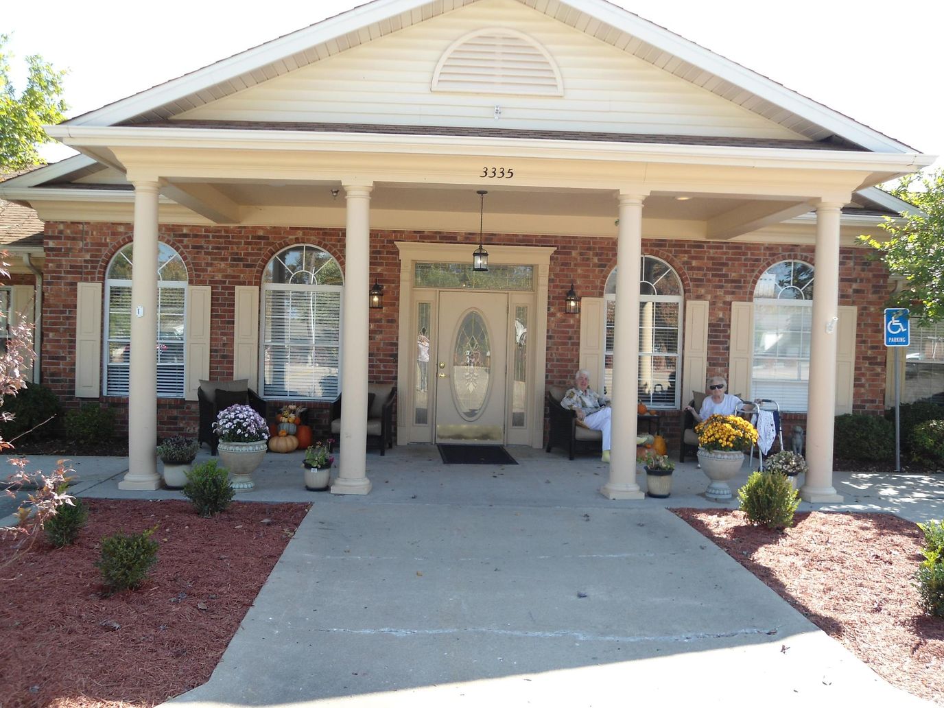 Entrance of a senior living facility with seating and decor