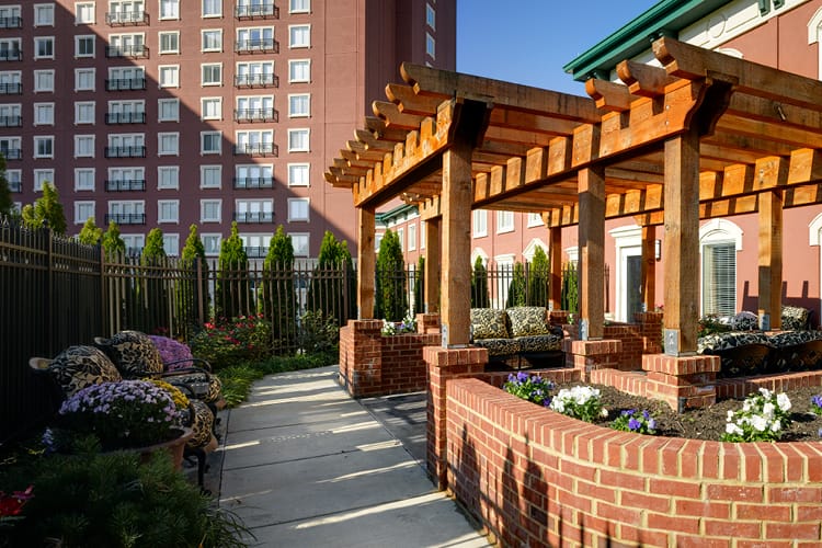 Outdoor seating area with colorful flowers and a building backdrop